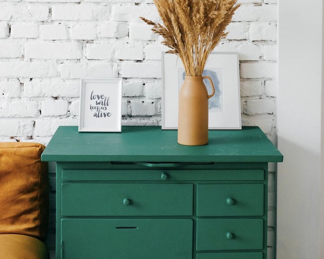 home decor on top of green drawers