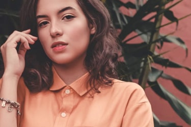 Model wearing a peach button up shirt